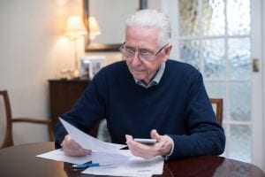 Concerned senior reviewing finances. Seniors who receive Social Security benefits often worry if filing for bankruptcy will affect their ability to receive disbursements