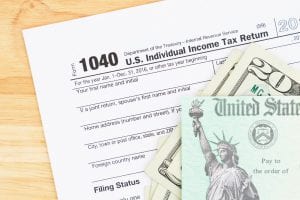 1040 income tax form with refund money. If you're considering filing for bankruptcy, you may be wondering how this will affect your tax refund.